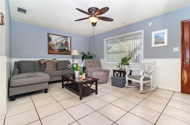 tiled living room with ceiling fan