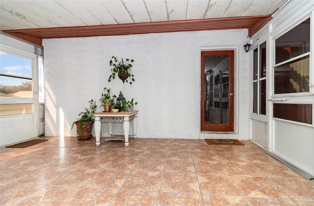 unfurnished sunroom featuring wooden ceiling