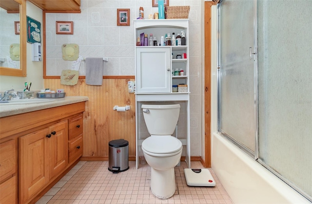 full bathroom with tile patterned flooring, vanity, toilet, and combined bath / shower with glass door