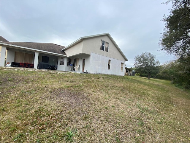 rear view of property with a lawn