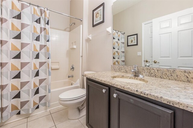 full bathroom featuring toilet, vanity, tile patterned floors, and shower / bath combo with shower curtain