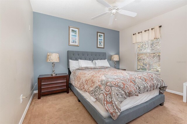 bedroom featuring ceiling fan and light colored carpet