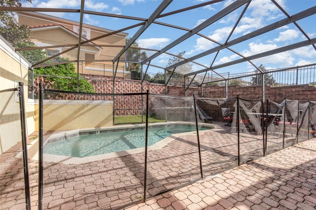 view of pool featuring a patio area and glass enclosure