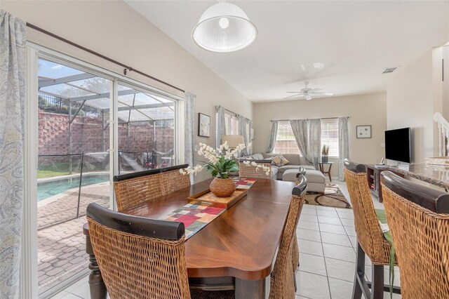 tiled dining space with ceiling fan