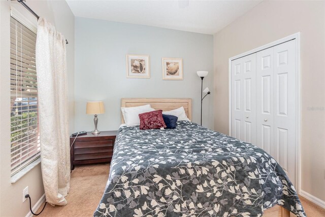 carpeted bedroom featuring a closet