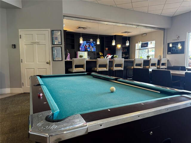 rec room featuring dark colored carpet, a paneled ceiling, billiards, and bar