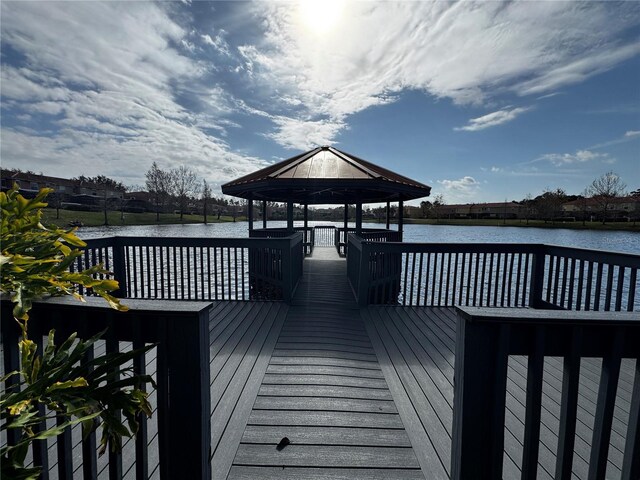 view of dock with a gazebo and a water view