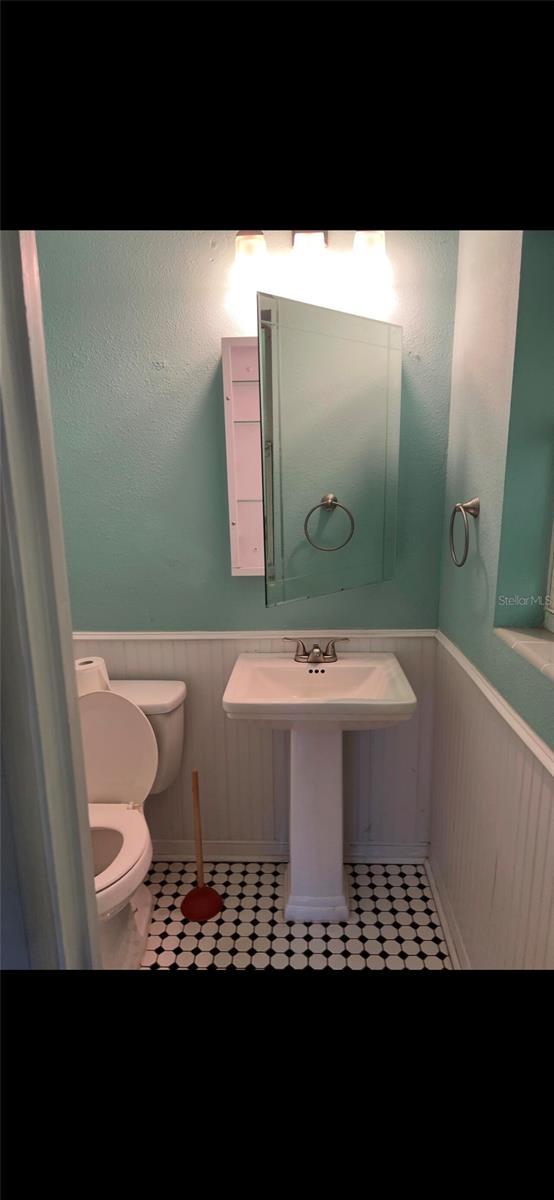 bathroom with tile patterned flooring and toilet