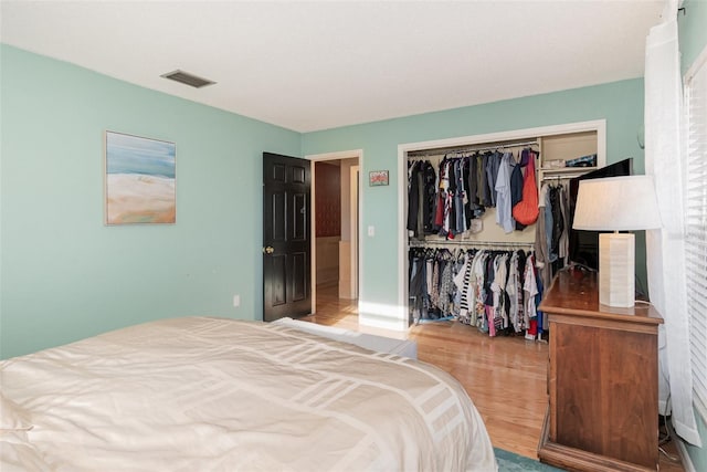 bedroom featuring light hardwood / wood-style flooring and a closet