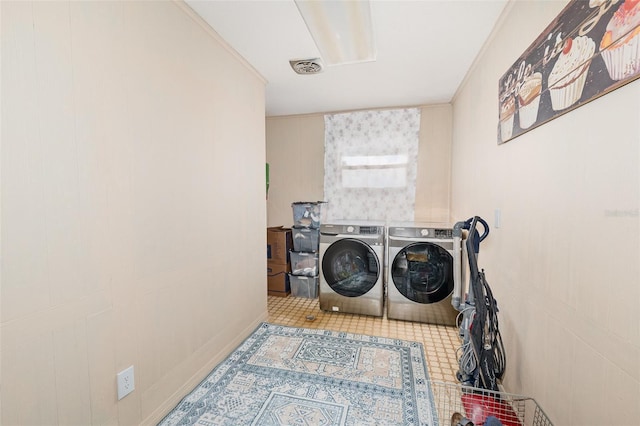 laundry area featuring washer and clothes dryer and ornamental molding