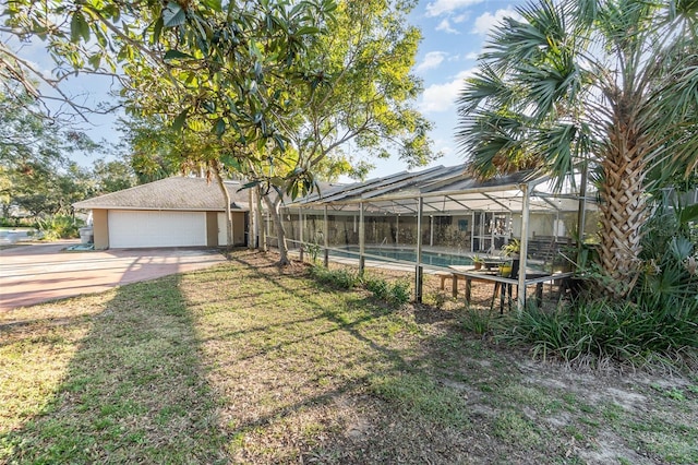 view of yard with a garage and a lanai