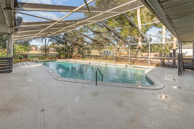 view of pool with a patio area and glass enclosure