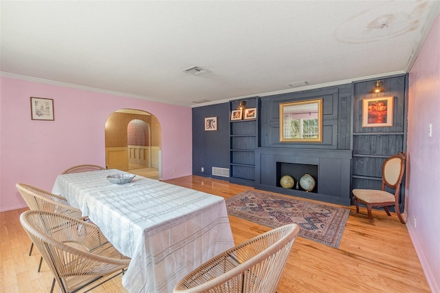 interior space with hardwood / wood-style flooring and ornamental molding