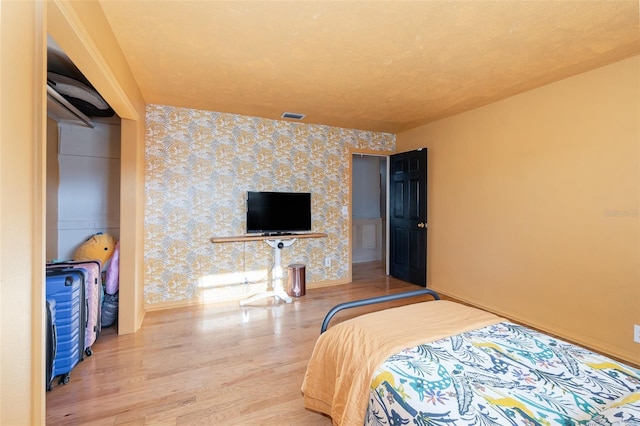 bedroom with hardwood / wood-style flooring