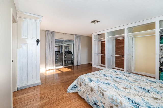 bedroom with hardwood / wood-style flooring