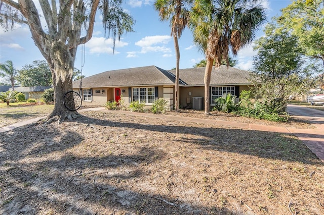 single story home featuring central AC unit