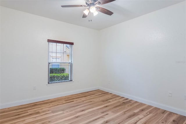 empty room with ceiling fan and light hardwood / wood-style flooring