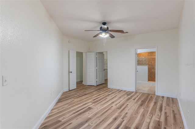 unfurnished bedroom featuring ensuite bath, ceiling fan, and light hardwood / wood-style flooring