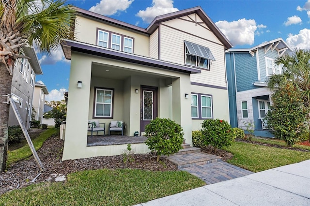 view of front of property with a front lawn and covered porch