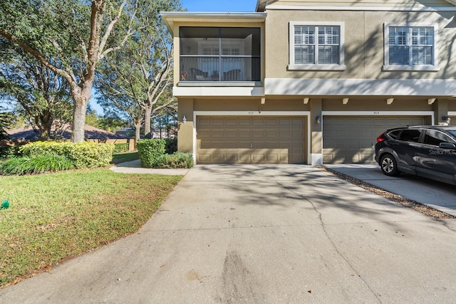 view of property with a front yard and a garage