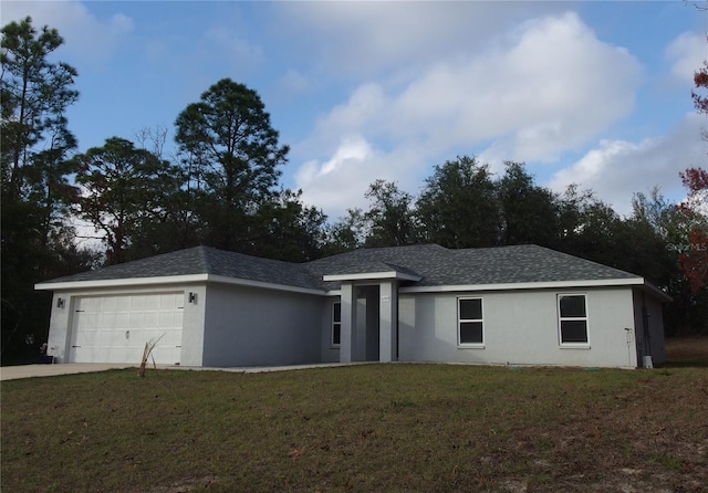 ranch-style house featuring a front lawn and a garage