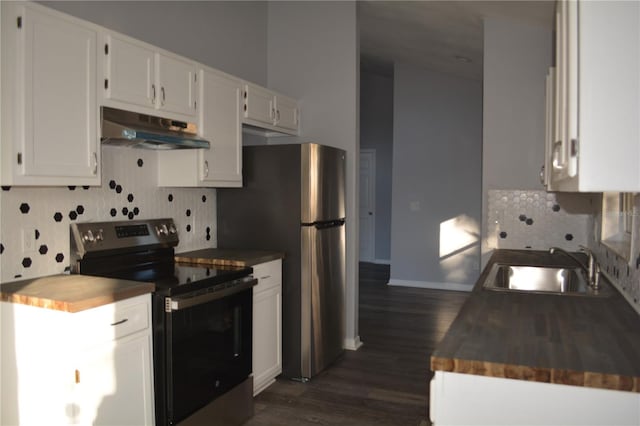 kitchen featuring dark hardwood / wood-style floors, sink, white cabinetry, stainless steel appliances, and butcher block counters