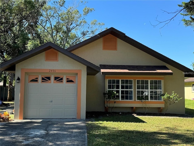 view of front of home with a front lawn and a garage