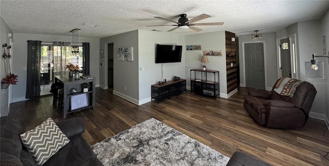 living room with a textured ceiling, ceiling fan, and dark hardwood / wood-style floors