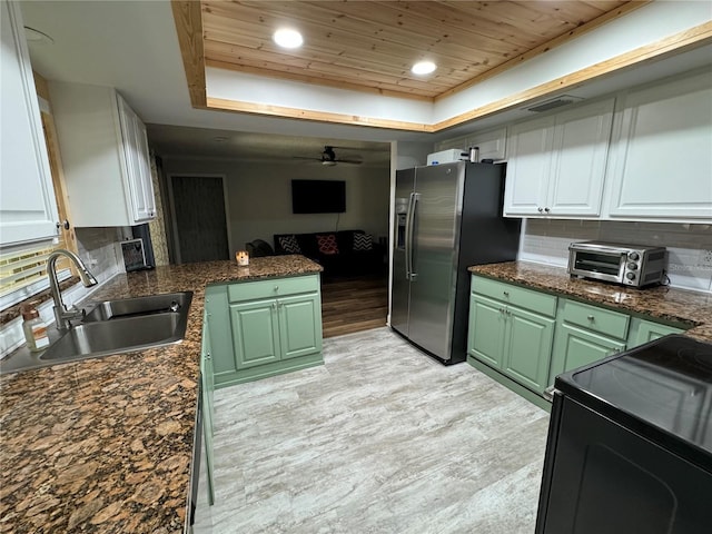 kitchen featuring wooden ceiling, backsplash, sink, range with electric cooktop, and white cabinetry