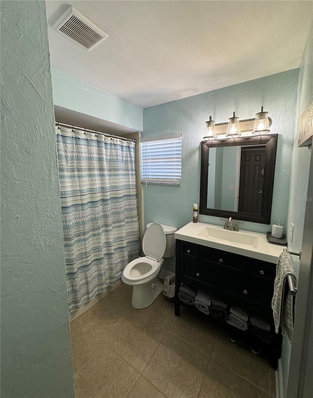 bathroom featuring vanity, a shower with shower curtain, and toilet