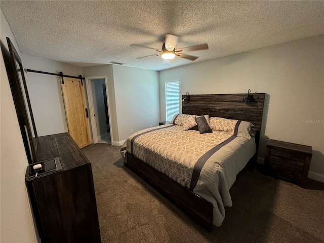 carpeted bedroom featuring a textured ceiling, a barn door, and ceiling fan