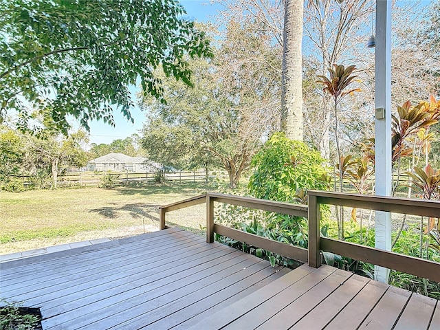 wooden deck featuring a lawn