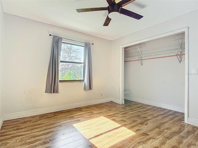 unfurnished bedroom with hardwood / wood-style floors, ceiling fan, and a closet