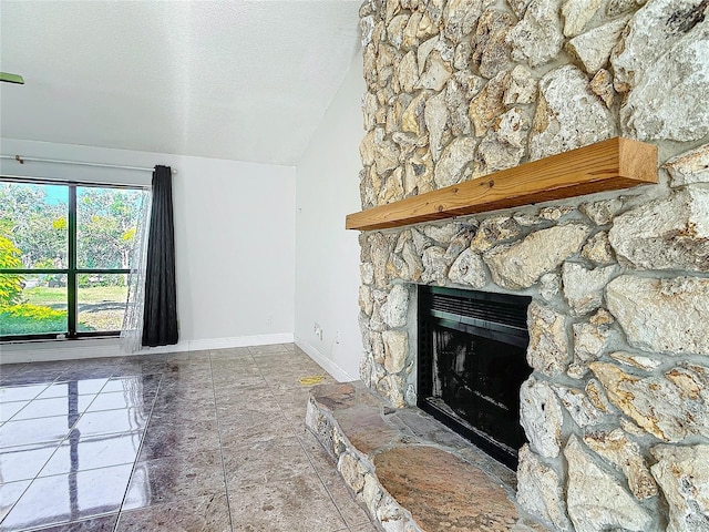 unfurnished living room featuring a fireplace, a textured ceiling, and lofted ceiling