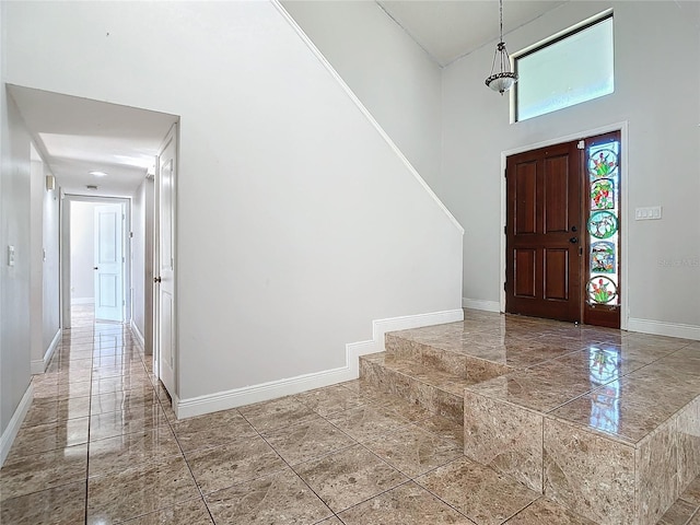 foyer entrance featuring a towering ceiling