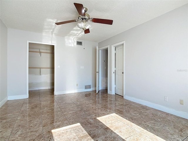 unfurnished bedroom featuring ceiling fan and a textured ceiling