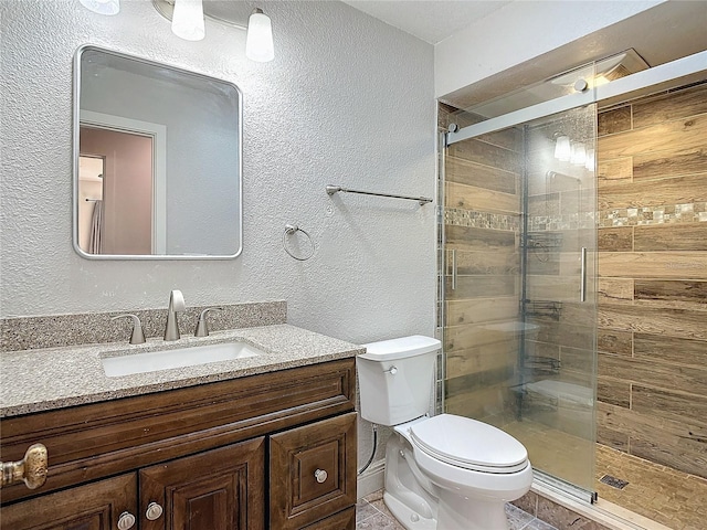 bathroom featuring vanity, toilet, and walk in shower