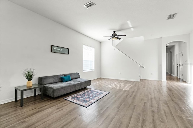 living room featuring ceiling fan and light hardwood / wood-style floors