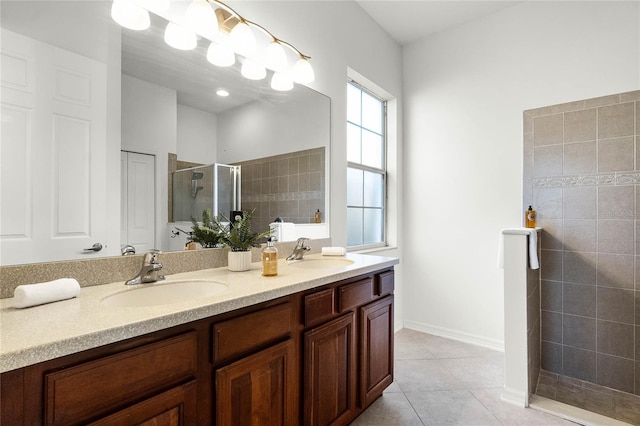 bathroom featuring tile patterned floors, a shower with door, and vanity