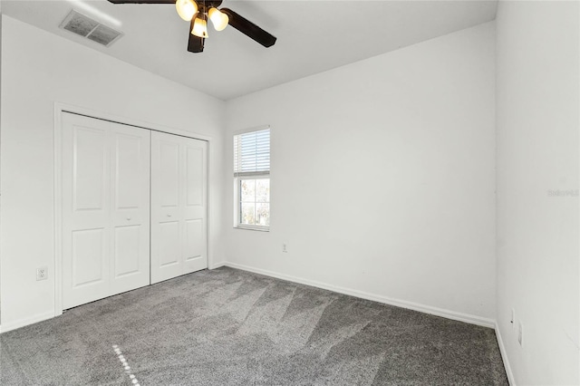 unfurnished bedroom with carpet floors, a closet, and ceiling fan