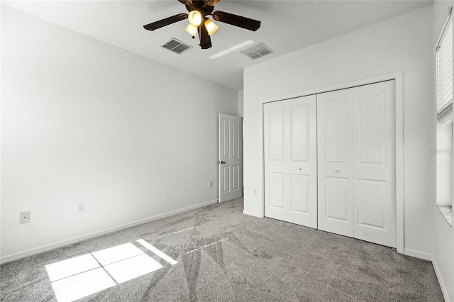 unfurnished bedroom featuring a closet, light colored carpet, and ceiling fan