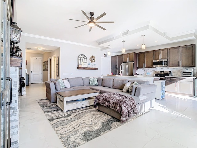 living room featuring ceiling fan and crown molding