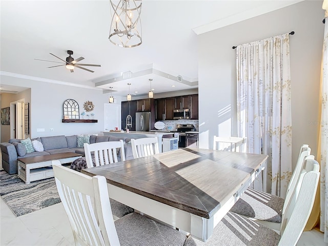 dining space featuring crown molding and ceiling fan with notable chandelier