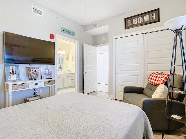 bedroom with ensuite bathroom and a closet