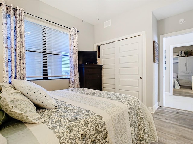 bedroom featuring hardwood / wood-style floors and a closet