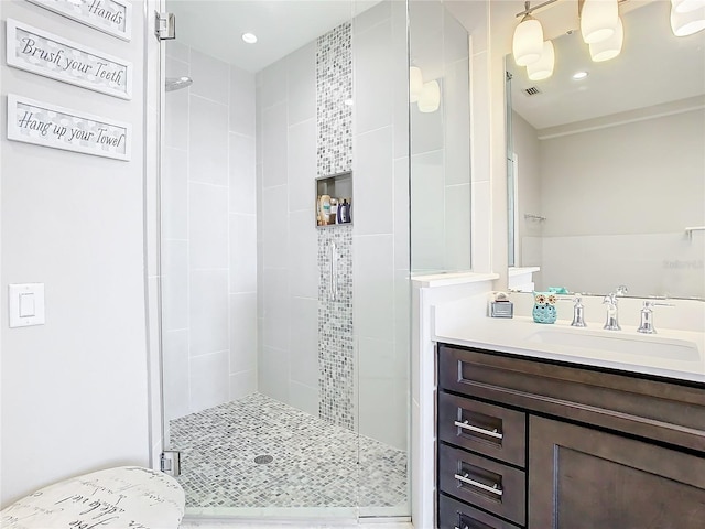 bathroom featuring an enclosed shower and vanity