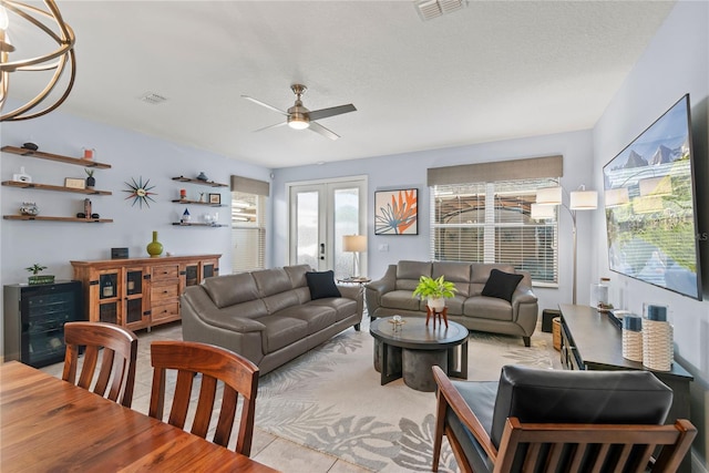 living room with beverage cooler, visible vents, a ceiling fan, french doors, and light tile patterned flooring