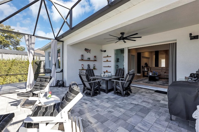 view of patio with a lanai, ceiling fan, and a grill