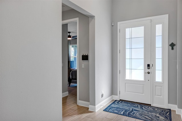 doorway to outside featuring ceiling fan