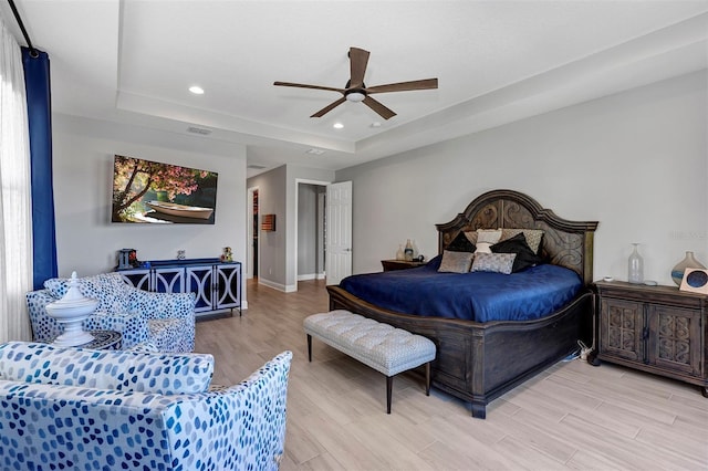 bedroom featuring ceiling fan and a raised ceiling